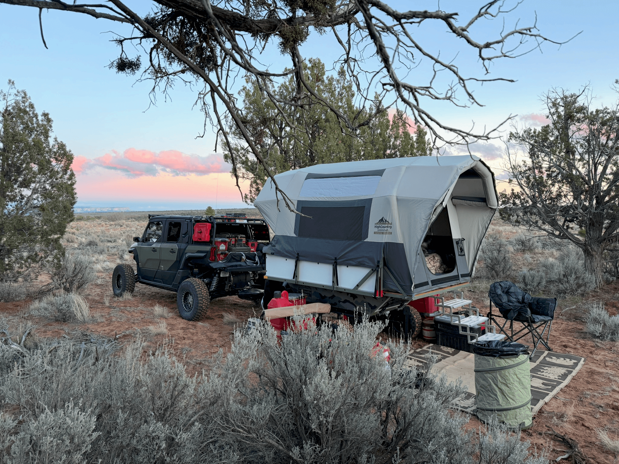 High Country Unlimited trailer paired with a UTV at a high-desert camp at dusk