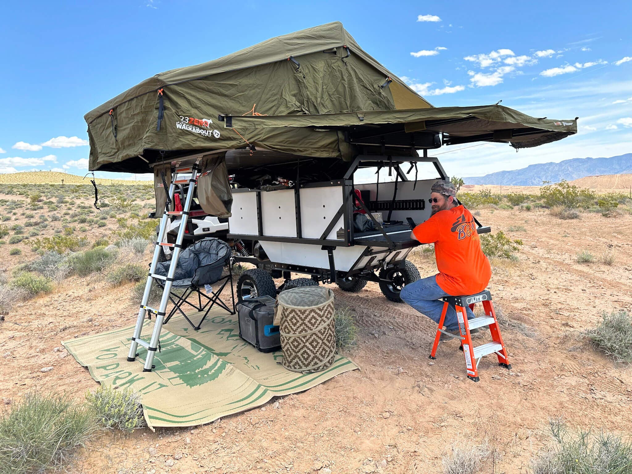 A High Country Unlimited overland trailer set up at a desert campsite after being towed in by a side-by-side